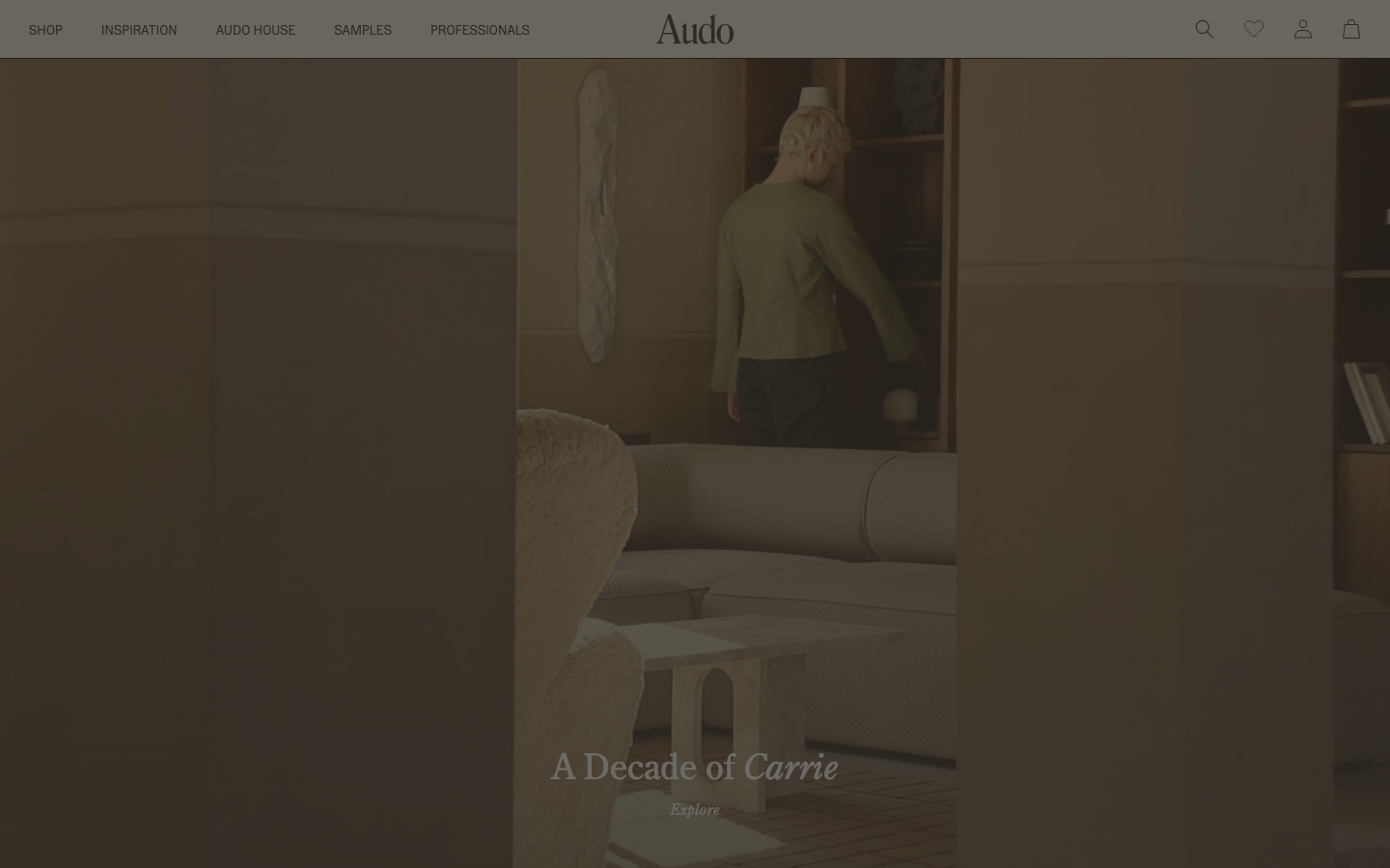 Audocph - The page uses a full-bleed image to establish a mood, with minimal text overlay. The color palette is muted and earthy, creating a sense of understated elegance. Typography is clean and legible, prioritizing visual impact over extensive information.  ·  minimalist portfolio, soft branding, editorial website, muted color palette, fullbleed image, calm aesthetic, studio website, clean typography, decade retrospective, audocph
