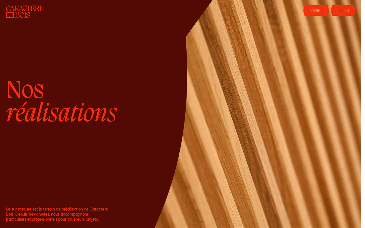 A high-contrast composition pairing a deep mahogany background with a curved, organic crop of a detailed wood grain photograph. The use of a bold, italicized serif typeface creates a sophisticated, artisanal mood.  ·  luxury woodworking hero, artisanal furniture web design, curved image crop, deep red and wood palette, editorial serif typography