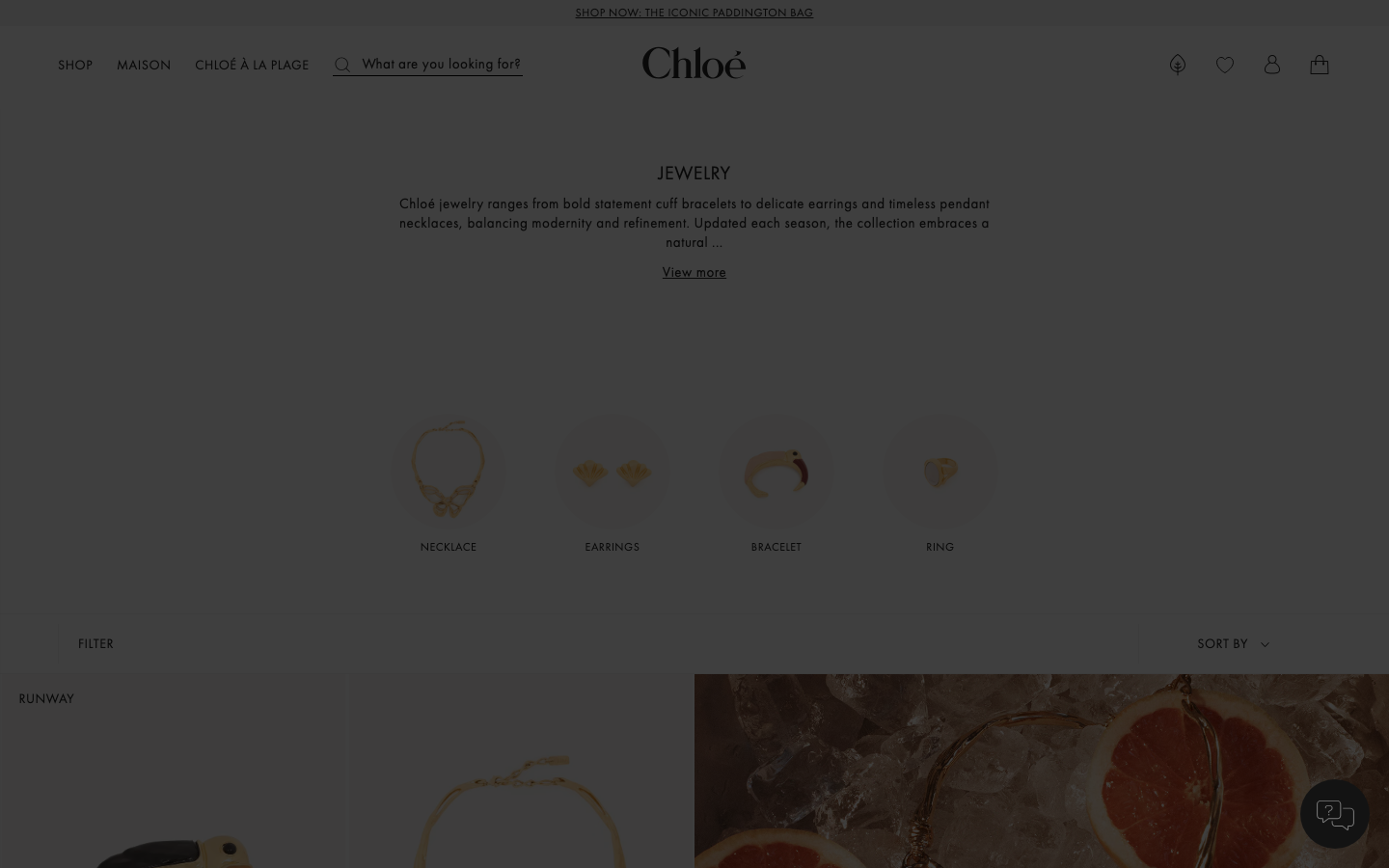 The image is the primary focus, presenting a relaxed, aspirational lifestyle. The muted color palette and soft lighting contribute to a serene and elegant mood. Typography is minimal, allowing the visual to dominate. · luxury fashion, summer collection, beachwear, editorial fashion, chloe spring, soft aesthetic, luxe lifestyle, minimalist fashion, fashion photography, spring campaign