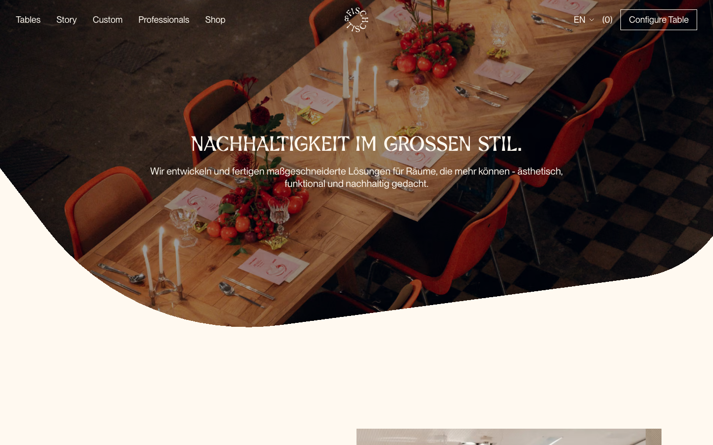 A high-impact hero section featuring a full-bleed lifestyle photograph with a curved bottom edge. Centered white sans-serif typography creates a clean, modern contrast against the rich, warm tones of the wooden table setting. · furniture hero, luxury interior web, curved image transition, editorial ecommerce, warm lifestyle photography