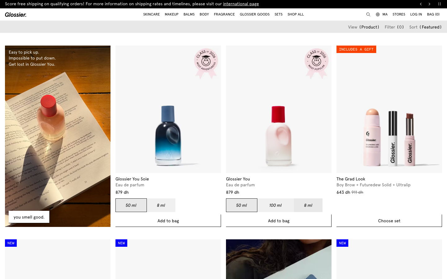 The hero image is a full-bleed shot of a Glossier bag overflowing with products, creating a sense of intimate curation. The typography is clean and modern, allowing the visual to take center stage. The overall feel is relaxed and aspirational. · beauty ecommerce, minimalist beauty, soft aesthetic, curated beauty, glossier branding, product showcase