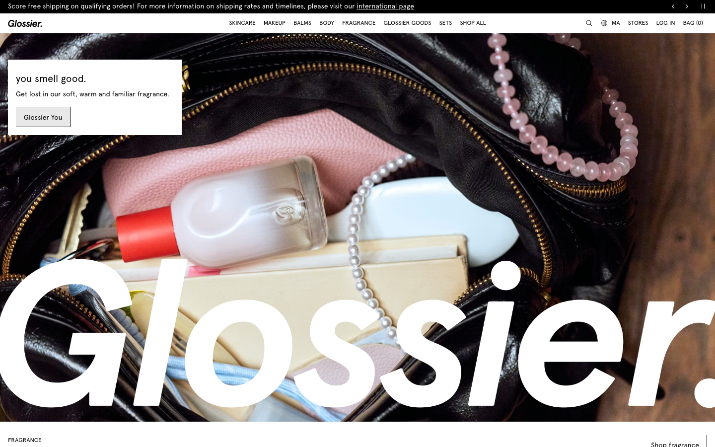 The hero image is a full-bleed shot of a Glossier bag overflowing with products, creating a sense of intimate curation. The typography is clean and modern, allowing the visual to take center stage. The overall feel is relaxed and aspirational. · beauty ecommerce, minimalist beauty, soft aesthetic, curated beauty, glossier branding, product showcase