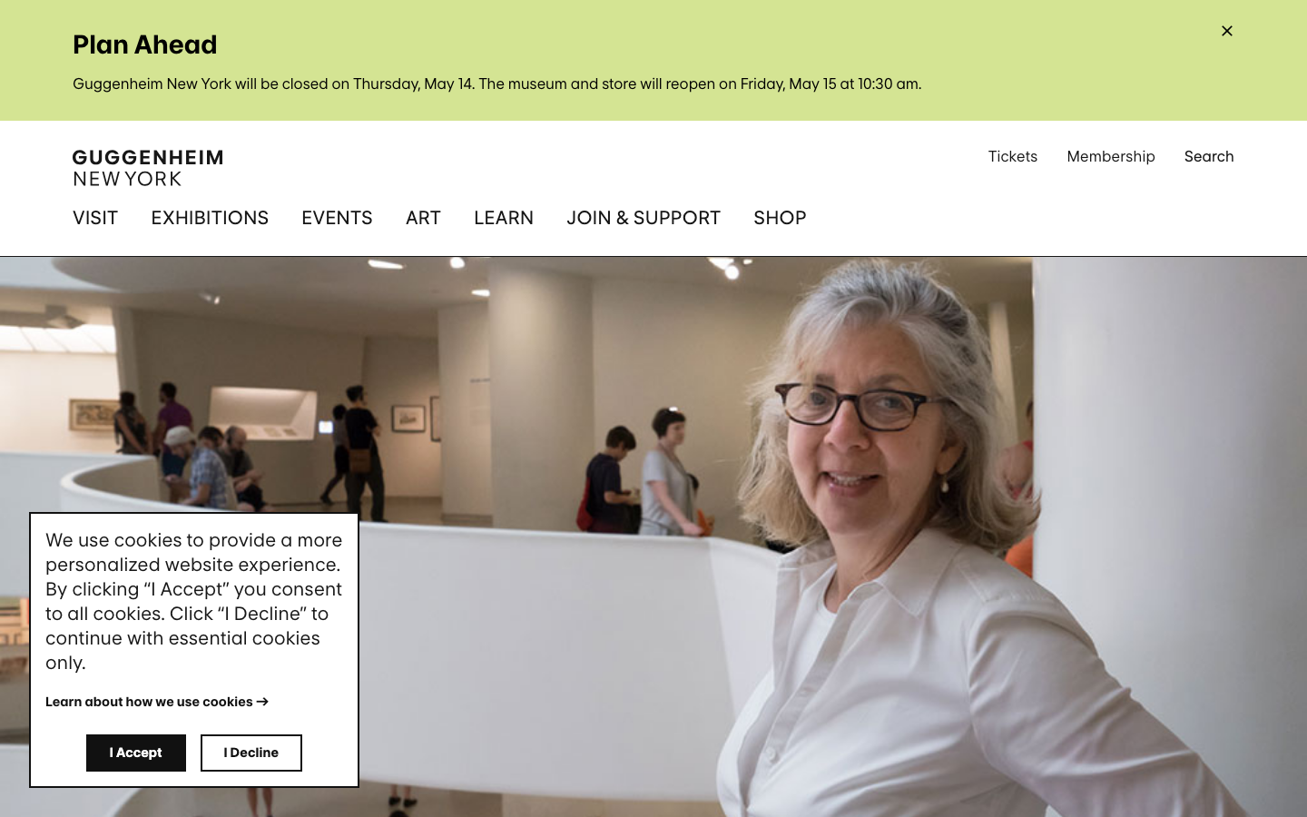 The page uses a split layout with a large, immersive image on the left and text on the right. The color palette is restrained, emphasizing the architectural space and the artwork within. Typography is clean and functional, prioritizing clarity and readability. · museum architecture, modern art, cultural institution, art gallery, minimalist design, public space, new york art, guggenheim visit