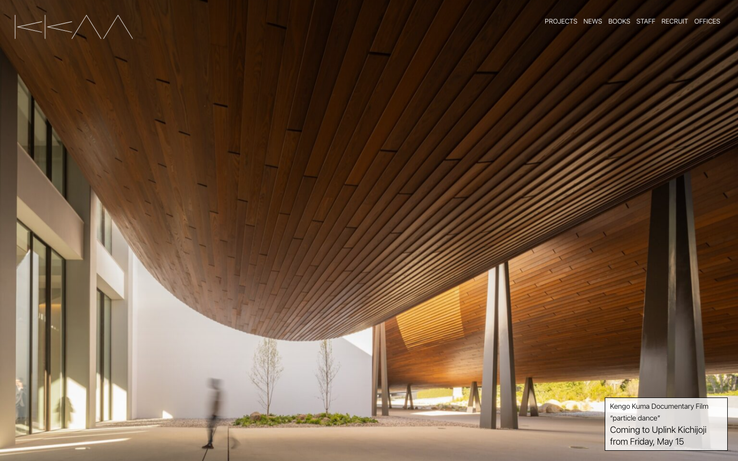 The page presents a sweeping aerial view of a modern architectural project, emphasizing its integration with the surrounding landscape. Clean typography and ample negative space create a sense of quiet confidence, prioritizing visual impact over dense information. · architectural project, landscape design, urban planning, modern architecture, aerial photography, kkaa, japan, landscape, riverfront